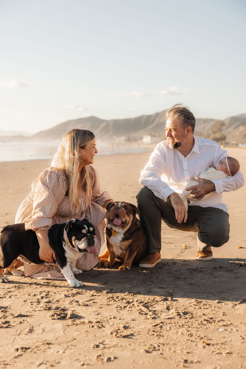 Ventura family photographer beach newborn session with parents and two English bulldogs