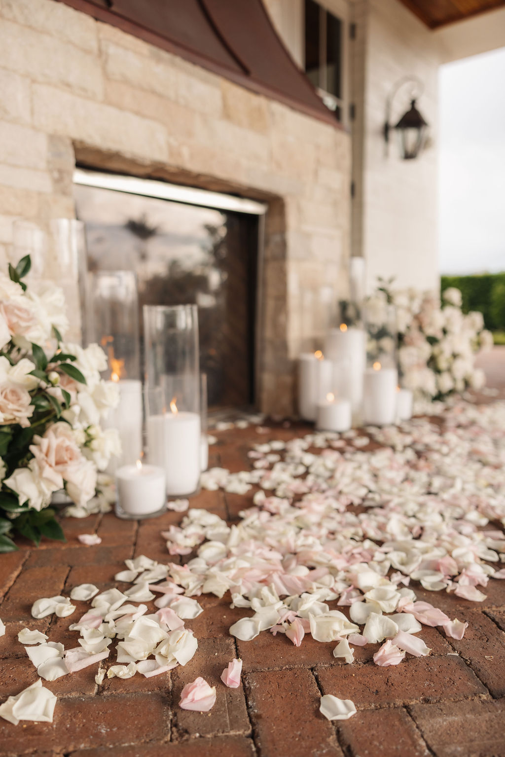 Glowing candles surrounding a floral installation inside The Study at Rosewood