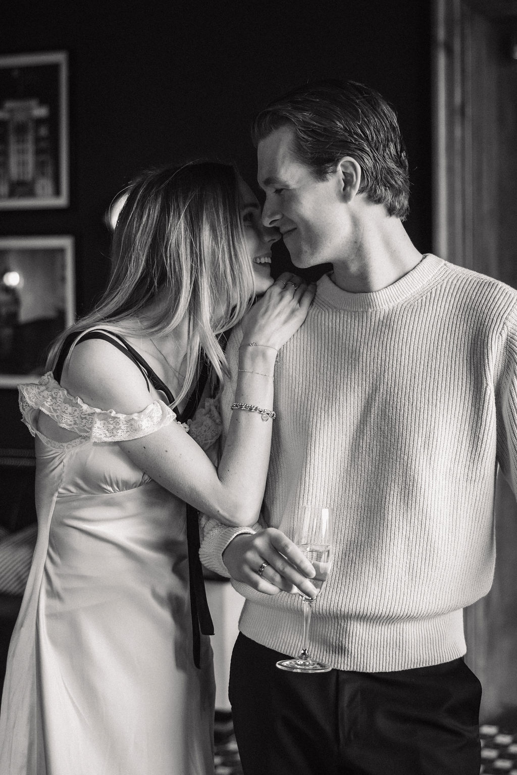 Couple snuggling with champagne glasses with a nostalgic old film feel