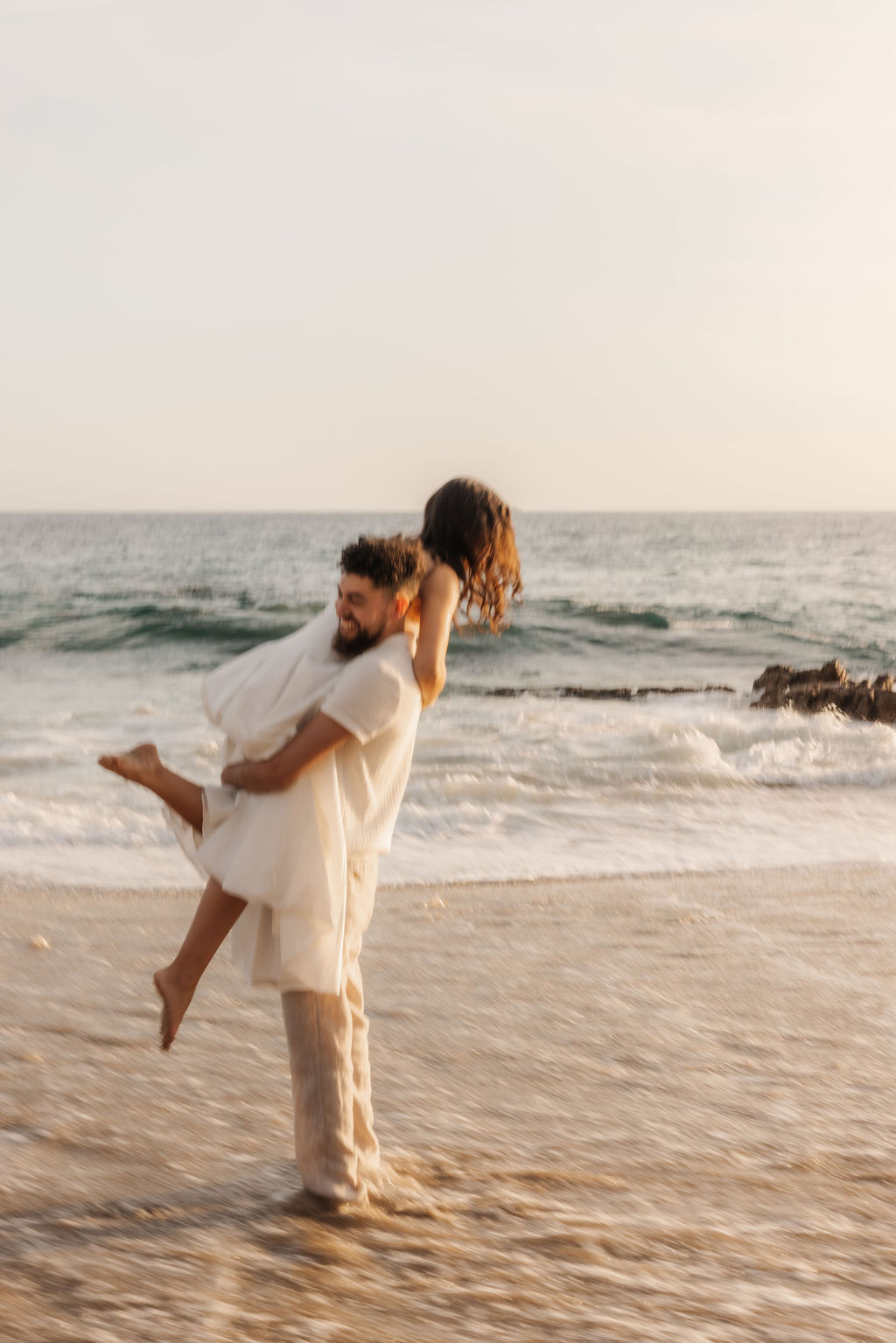 Epic wide-angle portrait of a couple on a Southern California beach by Santa Barbara wedding photographer
