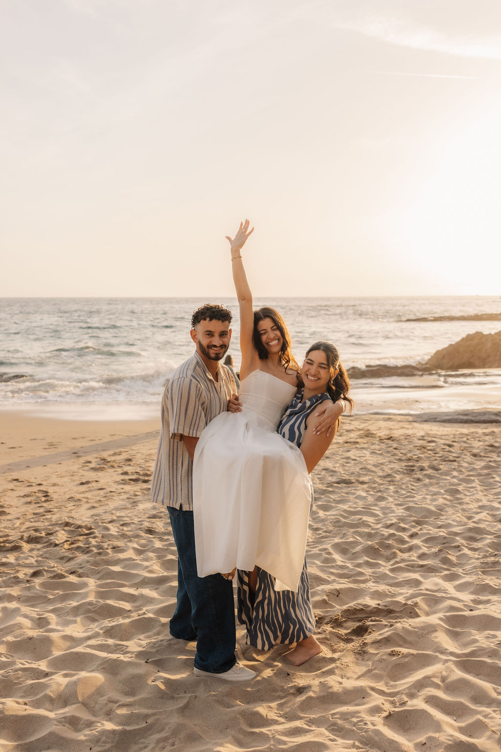 Unscripted family reactions during a surprise beach proposal by Ojai wedding photographer